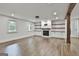 Bright living room featuring hardwood floors, a cozy fireplace with built-in shelves, and large windows at 270 Carrolls Way, Fayetteville, GA 30215