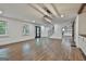 Open-concept living room with wood floors, view to staircase, and modern light fixture at 270 Carrolls Way, Fayetteville, GA 30215