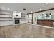 Spacious living area with hardwood floors, a modern fireplace, built-in shelving, and seamless flow to the kitchen at 270 Carrolls Way, Fayetteville, GA 30215