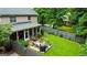 A well-manicured backyard features a patio with outdoor seating, a screened-in porch, and lush landscaping at 1120 Upchurch Rd, Mcdonough, GA 30252