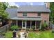 Backyard view of a two story brick home with a screened-in porch and patio at 1120 Upchurch Rd, Mcdonough, GA 30252