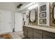 Bathroom features decorative mirrors, granite countertops, and ample storage at 1120 Upchurch Rd, Mcdonough, GA 30252