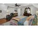 Bedroom featuring a ceiling fan, window and decorative patchwork quilt, settee and dark hardwood floors at 1120 Upchurch Rd, Mcdonough, GA 30252