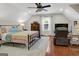 Spacious bedroom features a ceiling fan, window and decorative patchwork quilt at 1120 Upchurch Rd, Mcdonough, GA 30252