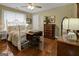 Comfortable bedroom featuring hardwood floors, vintage furniture and natural light at 1120 Upchurch Rd, Mcdonough, GA 30252