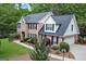 Brick home with a spacious lawn and well-kept landscaping, showcasing an attached garage at 1120 Upchurch Rd, Mcdonough, GA 30252