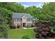 Traditional brick home with manicured landscaping and mature trees surrounding the property at 1120 Upchurch Rd, Mcdonough, GA 30252