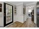 Welcoming hallway with wood flooring, leading to various rooms in the house at 1120 Upchurch Rd, Mcdonough, GA 30252