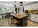Open-concept kitchen with an island, bar stools, and an adjacent dining area at 1120 Upchurch Rd, Mcdonough, GA 30252
