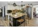 Well-equipped kitchen featuring white cabinets, a stainless steel fridge, and a large granite island at 1120 Upchurch Rd, Mcdonough, GA 30252