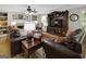 Cozy living room with a fireplace, built-in shelving, and a large entertainment center at 1120 Upchurch Rd, Mcdonough, GA 30252
