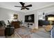 Comfortable living room featuring a large TV, ceiling fan, and neutral-toned furniture at 1120 Upchurch Rd, Mcdonough, GA 30252