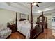 Elegant main bedroom with four poster bed, hardwood floors, and bright recessed lighting at 1120 Upchurch Rd, Mcdonough, GA 30252