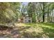 Lush backyard with trees surrounding the home at 405 Abbey Rd, Peachtree City, GA 30269