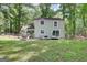 Exterior view of the house showcasing the large backyard with a covered patio at 405 Abbey Rd, Peachtree City, GA 30269