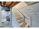 Basement stairs with wood railing and access to laundry area at 405 Abbey Rd, Peachtree City, GA 30269