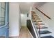 Bright entryway with wood-look floors, painted walls and a staircase with wood railings and modern balusters at 405 Abbey Rd, Peachtree City, GA 30269