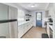 Bright kitchen with white cabinets, marble countertops, stainless steel appliances, and modern fixtures at 405 Abbey Rd, Peachtree City, GA 30269