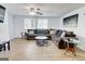Spacious living room with a large sectional sofa, ceiling fan, and light-colored wood-look flooring at 405 Abbey Rd, Peachtree City, GA 30269