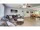 Open-concept living room featuring a large sectional, modern decor, and abundant natural light at 405 Abbey Rd, Peachtree City, GA 30269