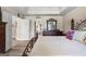 Comfortable main bedroom featuring a decorative iron bed frame, ceiling detail, and private access to bathroom at 105 Roxbrough Ln, Fayetteville, GA 30215