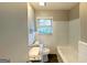 Bright bathroom featuring a granite vanity top, tiled walls, and a combined shower-tub at 2103 Keheley Dr, Decatur, GA 30032