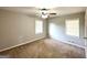 Cozy bedroom with ceiling fan, carpet floors, and natural light from two windows at 2103 Keheley Dr, Decatur, GA 30032