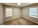 Bright bedroom with plush carpet and natural lighting from two large windows at 2103 Keheley Dr, Decatur, GA 30032