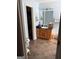 Bathroom with wood vanity, tiled floors, and a view into a walk-in closet at 120 Alfred Dr, Carrollton, GA 30116