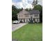 Inviting two-story home with neutral siding, well-maintained lawn, and paved driveway, perfect for suburban living at 120 Alfred Dr, Carrollton, GA 30116