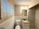 Cozy bathroom featuring granite vanity with tiled floors and window for natural lighting at 3456 Spring Cir, Decatur, GA 30032