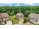 Aerial shot showcases a well-manicured front yard with a two-car garage home at 1492 Bourdon Bell Se Dr, Conyers, GA 30013