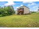 Expansive backyard featuring a wooden deck and lush greenery at 1492 Bourdon Bell Se Dr, Conyers, GA 30013