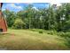 Lush, green backyard with mature trees and shrubs, offering privacy and tranquility at 1492 Bourdon Bell Se Dr, Conyers, GA 30013