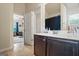 Bathroom with single vanity, a large mirror, and a doorway that leads to another bedroom at 1492 Bourdon Bell Se Dr, Conyers, GA 30013