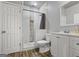Updated bathroom with a tiled shower, modern vanity, and hardwood floors at 1492 Bourdon Bell Se Dr, Conyers, GA 30013