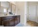 Elegant primary bathroom with dual sinks, dark wood cabinetry, and ample counter space at 1492 Bourdon Bell Se Dr, Conyers, GA 30013