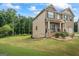Charming two-story house boasting manicured lawn and brick-accented porch at 1492 Bourdon Bell Se Dr, Conyers, GA 30013