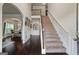 Grand foyer featuring dark hardwood floors, staircase, and an arched entryway into the dining room at 1492 Bourdon Bell Se Dr, Conyers, GA 30013