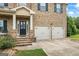 Inviting brick home featuring a two-car garage and a welcoming front entrance at 1492 Bourdon Bell Se Dr, Conyers, GA 30013
