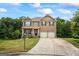 Charming two-story brick home with a well-manicured lawn and a two-car garage at 1492 Bourdon Bell Se Dr, Conyers, GA 30013
