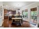Charming kitchen with dark wood cabinets, stainless appliances, island, and hardwood floors at 1492 Bourdon Bell Se Dr, Conyers, GA 30013