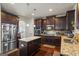 Spacious kitchen with dark wood cabinetry, granite countertops, stainless steel appliances, and a center island at 1492 Bourdon Bell Se Dr, Conyers, GA 30013