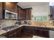 Well-appointed kitchen features granite countertops, stainless steel appliances, and a gas cooktop at 1492 Bourdon Bell Se Dr, Conyers, GA 30013