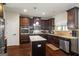 Gourmet kitchen with dark cabinetry, granite countertops, stainless steel appliances, and center island at 1492 Bourdon Bell Se Dr, Conyers, GA 30013