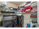 Well-equipped laundry room with modern washer and dryer, plus wire shelving for optimal storage at 1492 Bourdon Bell Se Dr, Conyers, GA 30013