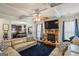 Open-concept living room with fireplace, coffered ceiling, and seamless flow to the kitchen area at 1492 Bourdon Bell Se Dr, Conyers, GA 30013