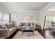 Cozy living room with crown molding, hardwood floors, stylish furniture, and lots of natural light at 1492 Bourdon Bell Se Dr, Conyers, GA 30013