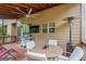 Relaxing covered patio with ceiling fan, outdoor TV, heater, and dining area, perfect for entertaining at 1492 Bourdon Bell Se Dr, Conyers, GA 30013