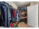 Organized walk-in closet with shelves, hanging racks, and storage solutions for clothing and shoes at 1492 Bourdon Bell Se Dr, Conyers, GA 30013